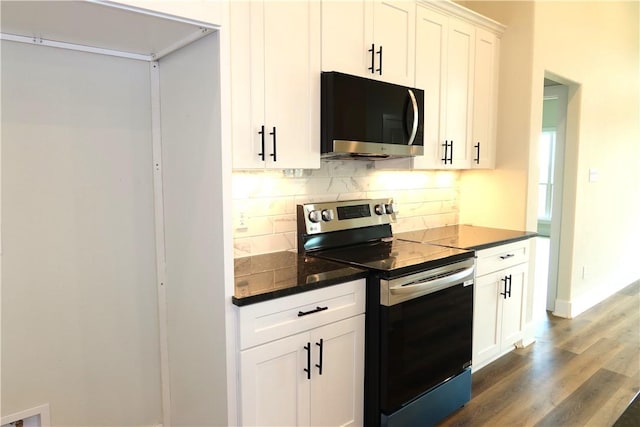 1977 Cambria Dr, Bryan, TX 77807 - kitchen with stainless steel appliances, decorative backsplash, dark wood-style floors, and white cabinetry