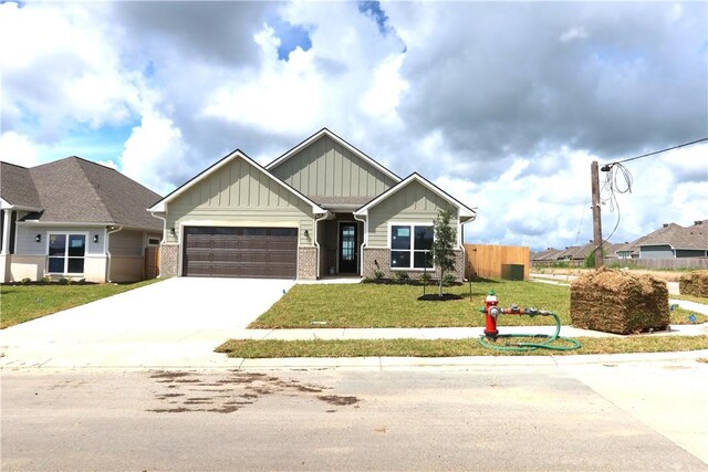 1977 Cambria Dr, Bryan, TX 77807 - craftsman-style house with board and batten siding, a garage, brick siding, and concrete driveway