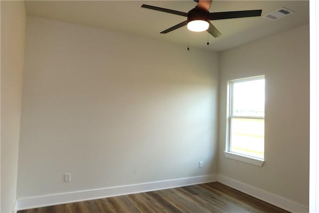 1977 Cambria Dr, Bryan, TX 77807 - spare room with healthy amount of natural light, dark wood-type flooring, and a ceiling fan
