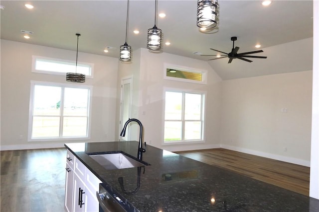 1977 Cambria Dr, Bryan, TX 77807 - kitchen with open floor plan, dark wood-type flooring, dark stone countertops, healthy amount of natural light, and recessed lighting