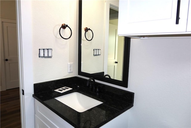 1977 Cambria Dr, Bryan, TX 77807 - bathroom featuring a sink and wood finished floors