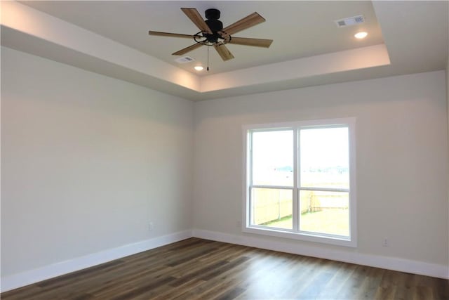1977 Cambria Dr, Bryan, TX 77807 - spare room featuring a tray ceiling, dark wood-type flooring, a ceiling fan, and recessed lighting