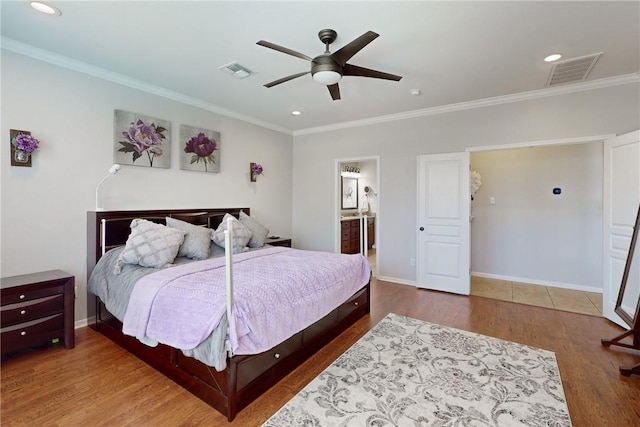 bedroom with hardwood / wood-style flooring, ceiling fan, crown molding, and connected bathroom