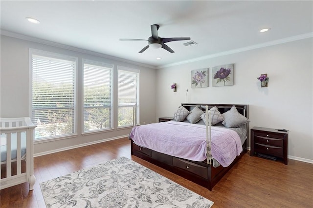 bedroom featuring ceiling fan, dark wood-type flooring, and ornamental molding