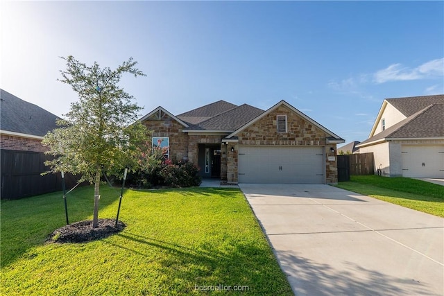 view of front of property with a front yard and a garage