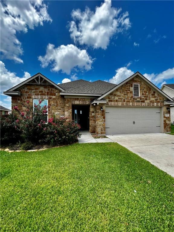 view of front of home with a front lawn and a garage