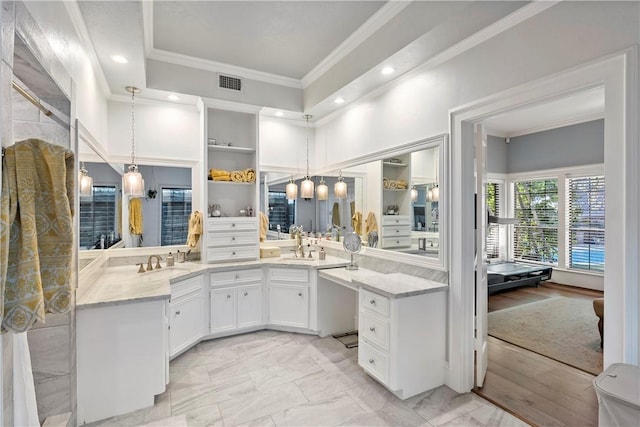 bathroom with vanity and ornamental molding