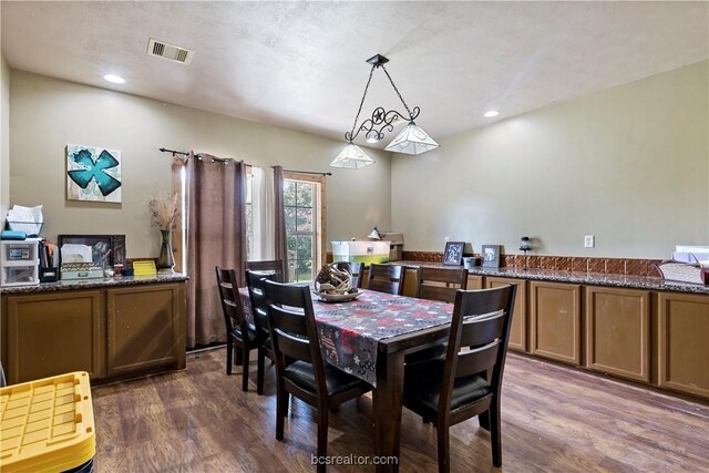 dining space with dark hardwood / wood-style flooring