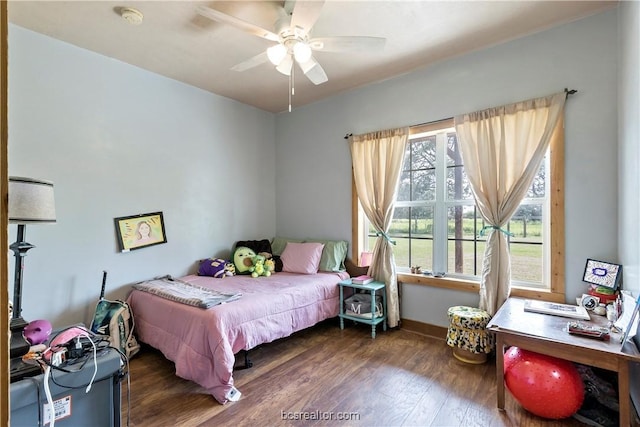 bedroom featuring ceiling fan and dark hardwood / wood-style floors