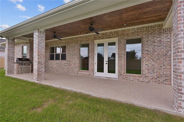 view of patio featuring a grill, ceiling fan, french doors, and exterior kitchen