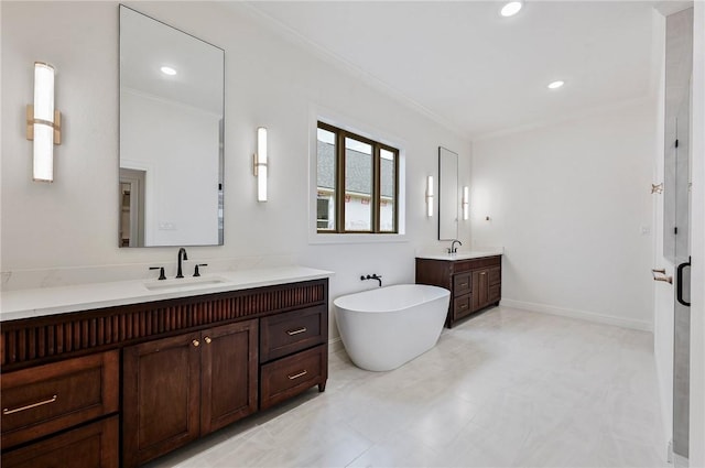 bathroom featuring crown molding, a bathtub, and vanity