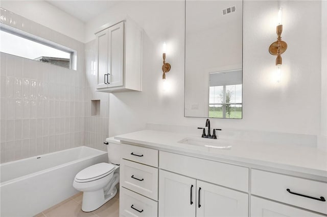 full bathroom featuring tile patterned floors, vanity, toilet, and a wealth of natural light