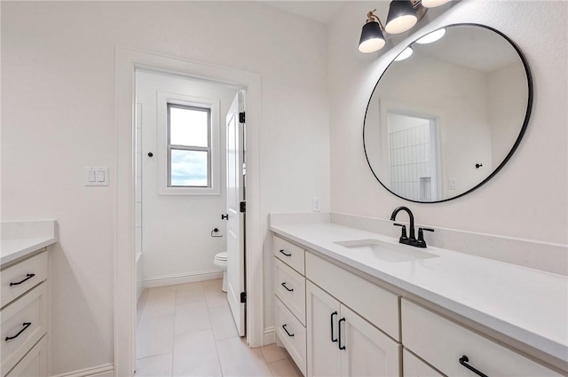 bathroom with tile patterned floors, vanity, and toilet