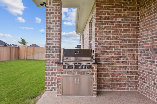 view of patio featuring area for grilling and a grill