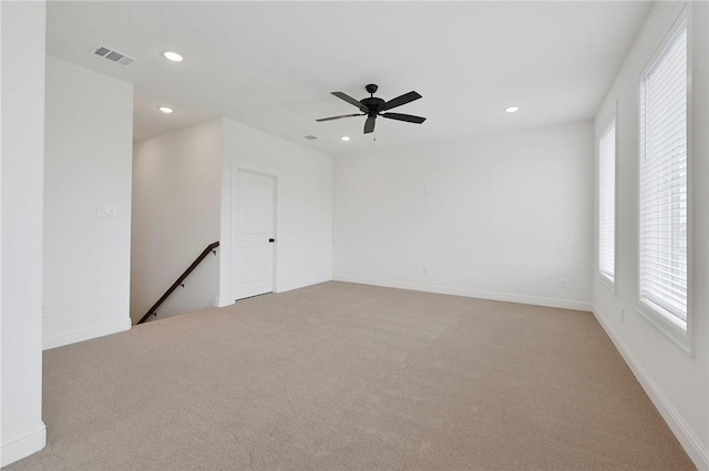 unfurnished room featuring ceiling fan and light colored carpet