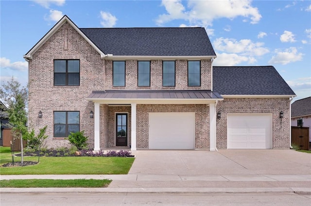 view of front of property featuring a garage and a front lawn