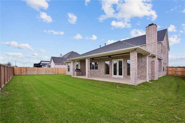 back of property featuring a yard, a patio area, ceiling fan, and french doors