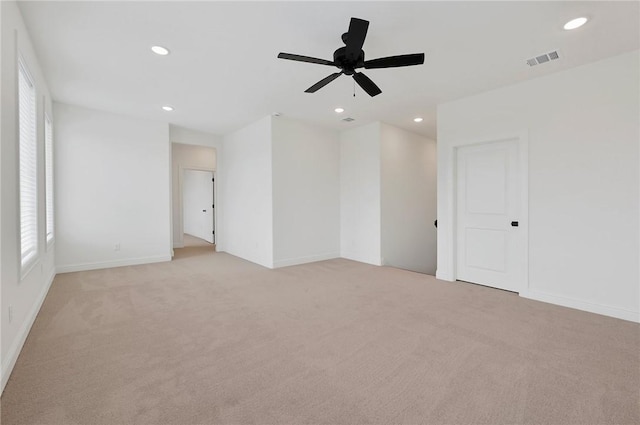 carpeted empty room featuring ceiling fan