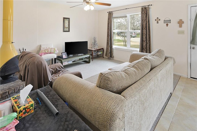 living room with ceiling fan and baseboards