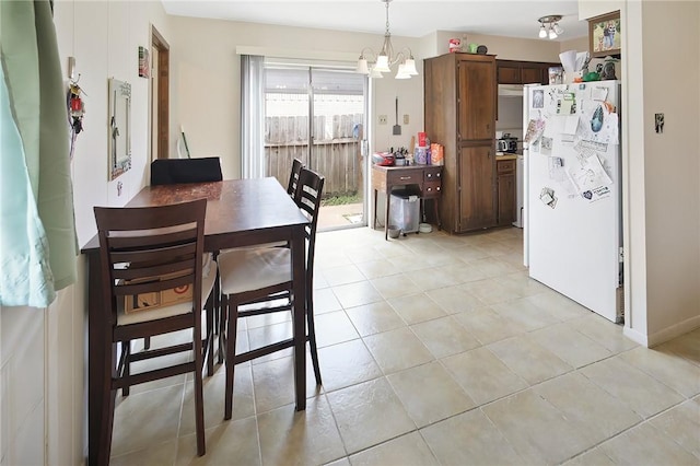 dining space with an inviting chandelier and light tile patterned floors