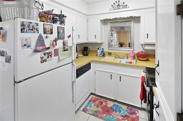 kitchen with light tile patterned flooring, white appliances, a sink, white cabinets, and light countertops