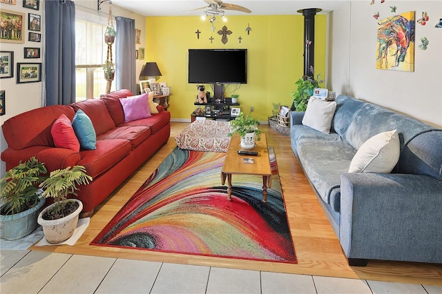 living area with wood finished floors and a ceiling fan