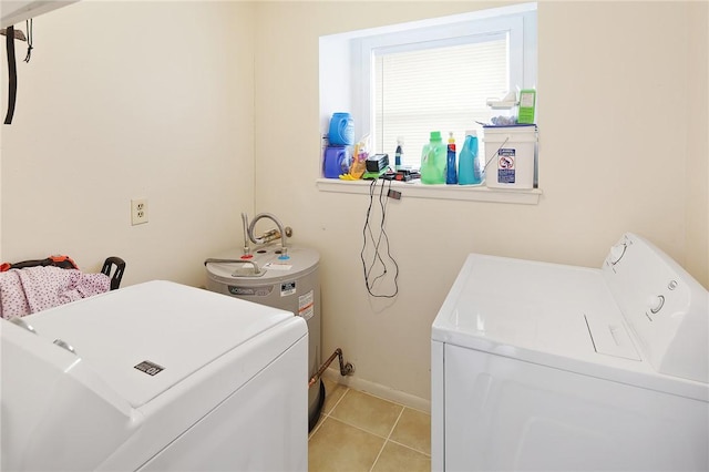 laundry area with laundry area, baseboards, independent washer and dryer, water heater, and light tile patterned flooring