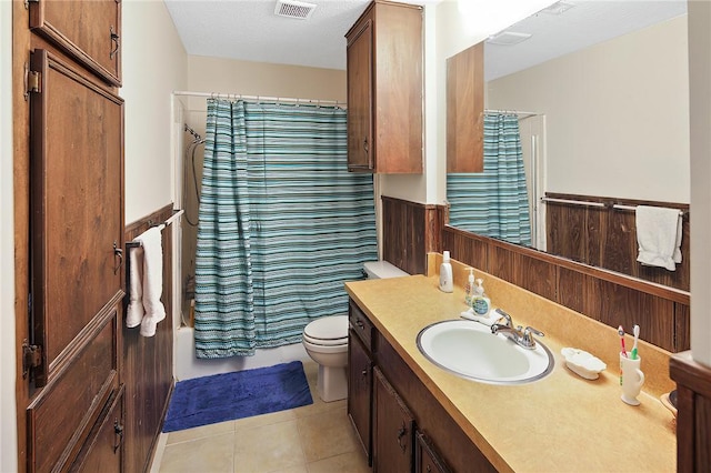 full bath featuring visible vents, toilet, wainscoting, vanity, and tile patterned flooring