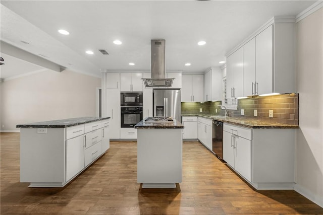 kitchen featuring white cabinetry, dark stone counters, island exhaust hood, a center island, and black appliances