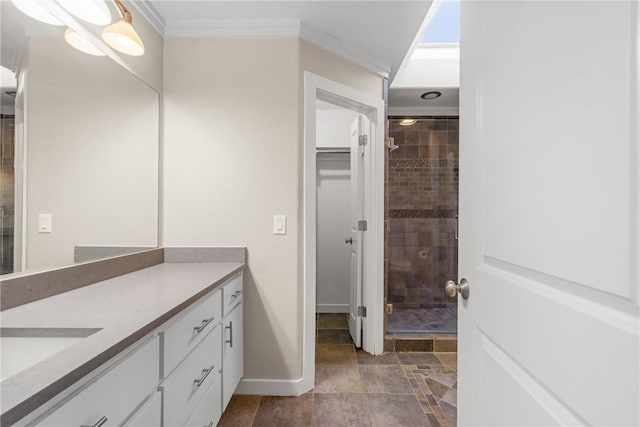 bathroom with ornamental molding, an enclosed shower, and vanity