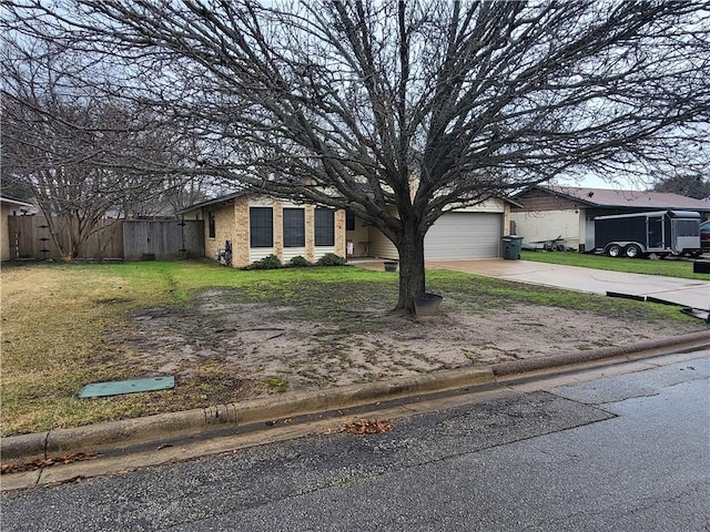 view of front of house featuring a garage, brick siding, fence, concrete driveway, and a front yard