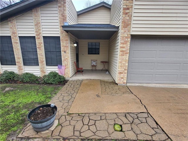 doorway to property with brick siding