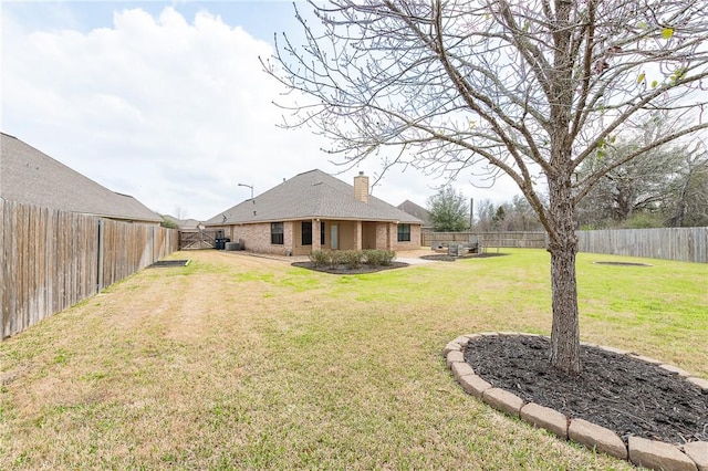 view of yard with a patio area and a fenced backyard