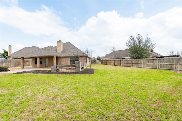 view of yard with a fenced backyard and a patio