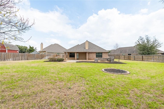 rear view of property with a fenced backyard, a patio, and a lawn