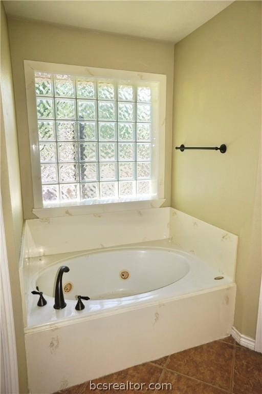 bathroom featuring tile patterned floors and a tub