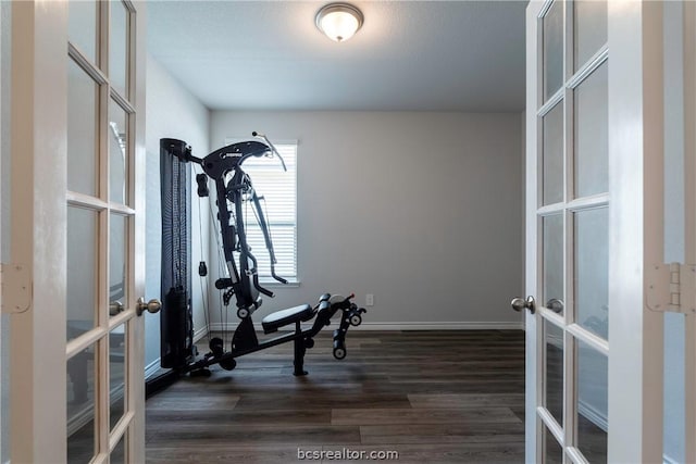 exercise room featuring french doors and dark hardwood / wood-style floors