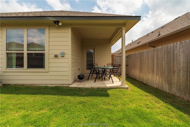 back of property featuring a lawn and a patio