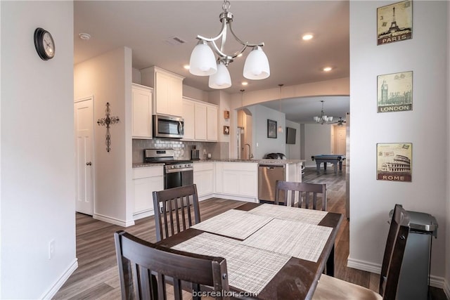 dining area featuring a chandelier, dark hardwood / wood-style flooring, sink, and billiards