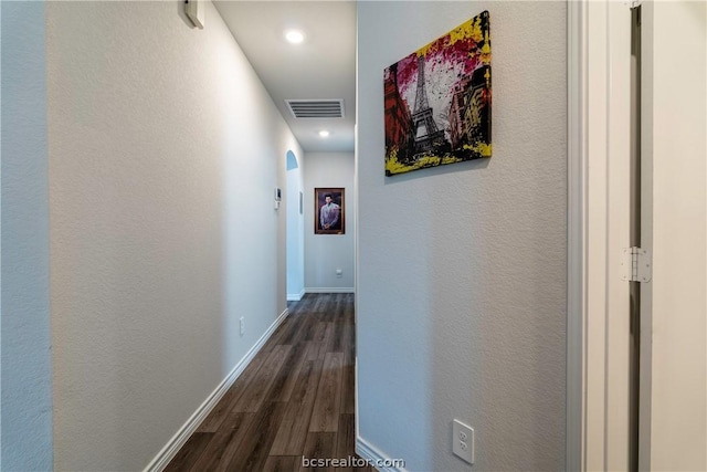 corridor with dark hardwood / wood-style flooring