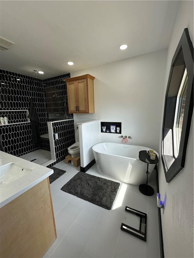 full bathroom featuring vanity, tile patterned floors, independent shower and bath, and toilet