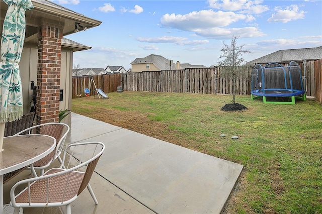 view of yard featuring a playground, a patio area, and a trampoline