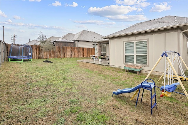 view of yard with a playground, a patio area, and a trampoline