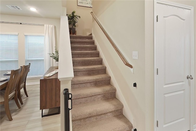 stairway featuring hardwood / wood-style flooring