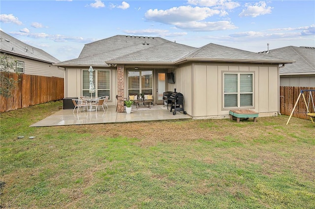 rear view of house featuring a patio area and a lawn