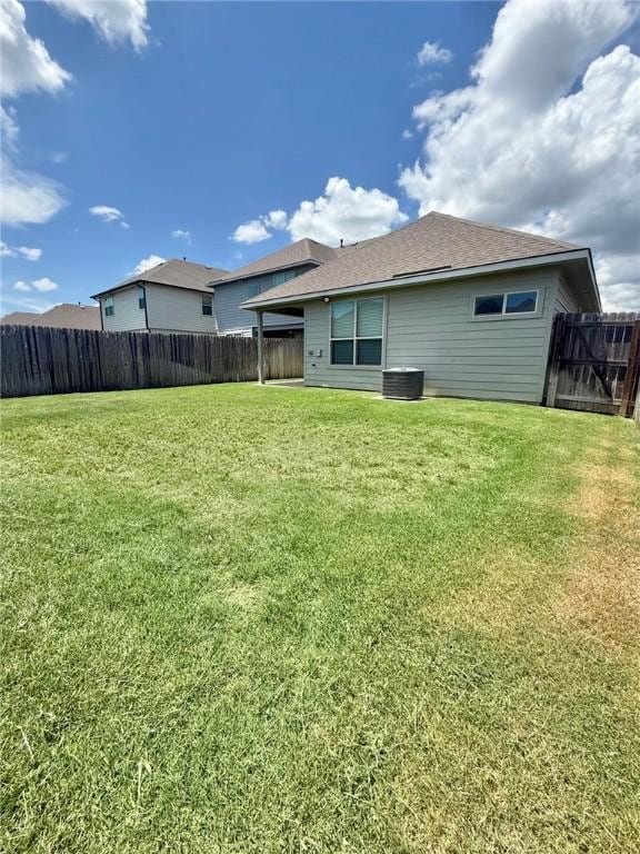 1074 Toledo Bend Dr, College Station, TX 77845 - back of house with a fenced backyard and roof with shingles
