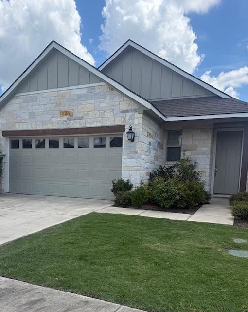 1074 Toledo Bend Dr, College Station, TX 77845 - ranch-style house with board and batten siding, stone siding, a garage, a shingled roof, and concrete driveway