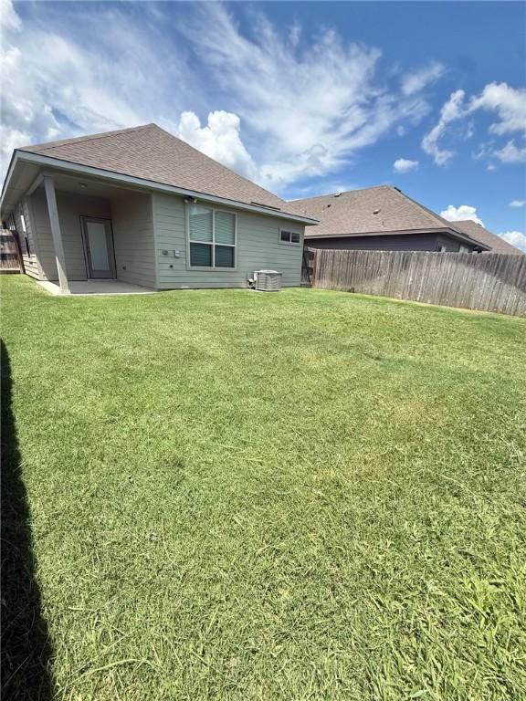 1074 Toledo Bend Dr, College Station, TX 77845 - rear view of house with roof with shingles and a patio area
