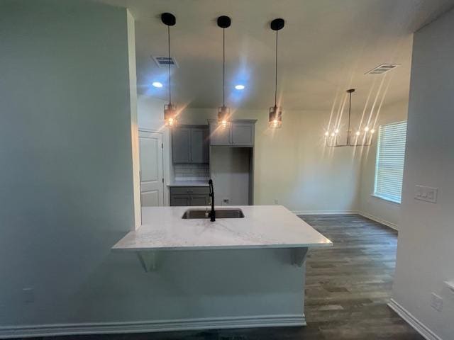2303 White Wing Dr, Navasota, TX 77868 - kitchen with a sink, a peninsula, baseboards, dark wood-type flooring, and recessed lighting
