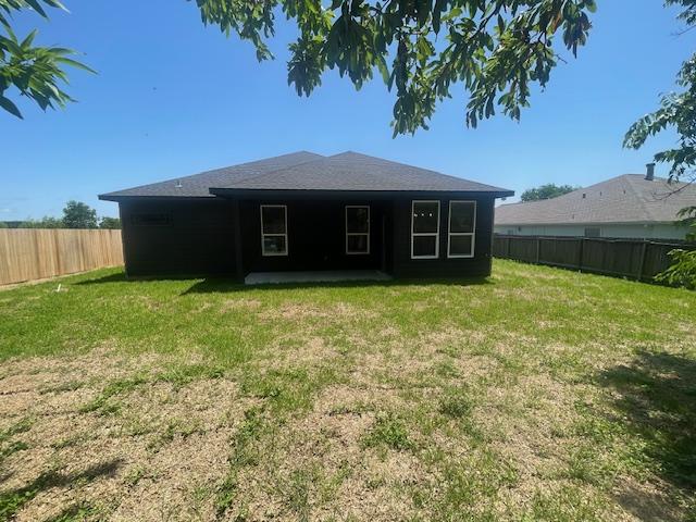 2303 White Wing Dr, Navasota, TX 77868 - rear view of house featuring a patio
